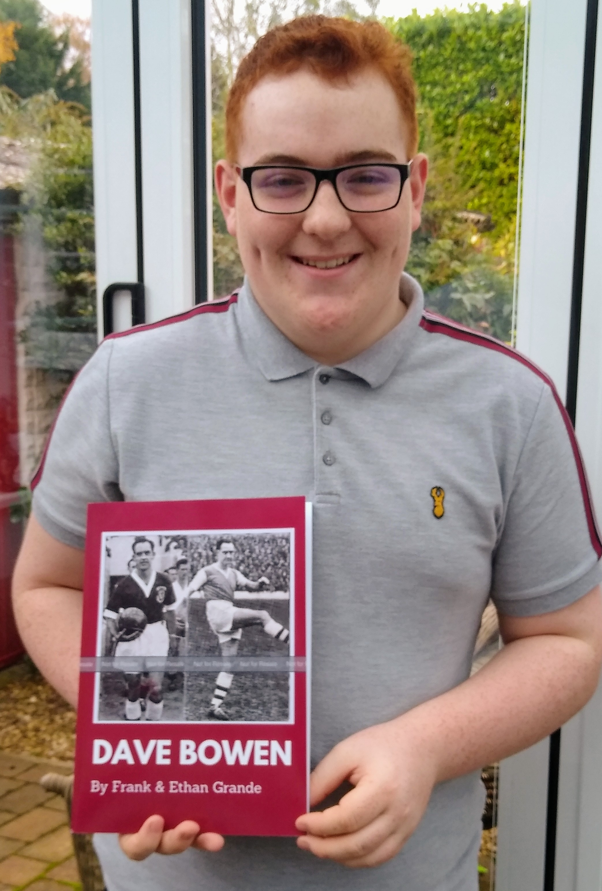 Ethan is pictured with the new football book, dedicated to the life and times of Northampton Town FC legend Dave Bowen